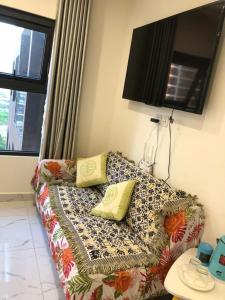 a couch with pillows on it in a living room at Anna Vinhomes Grand Park in Ho Chi Minh City