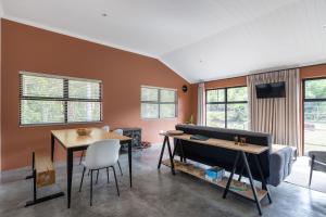 a living room with a couch and a table at Cape Dutch Stay, Suite B in Sedgefield