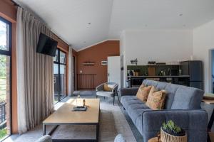 a living room with a couch and a table at Cape Dutch Stay, Suite B in Sedgefield