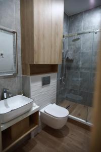 a bathroom with a toilet sink and a shower at Isra City Hotel in Dushanbe