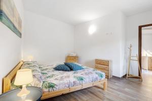 a bedroom with a bed and a table and a lamp at Casa Vacanze Il Primo Sole in Finale Ligure