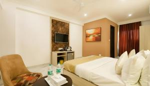 a hotel room with a bed and a chair at Hotel Stay Premium- Free Airport Tranffer in New Delhi