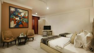 a bedroom with two beds and a television in it at Hotel Stay Premium- Free Airport Tranffer in New Delhi +36 photos