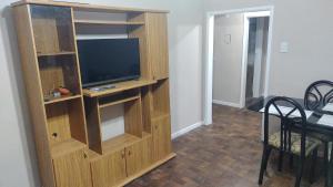 a wooden entertainment center with a television in a living room at Edén in La Falda