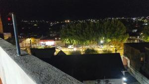 a view of a city at night with lights at Edén in La Falda