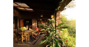 a porch of a house with a table and chairs at Oloile - Home By The Park in Nairobi