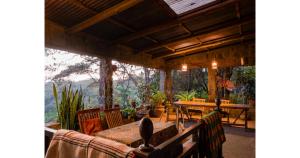a dining room with a table and a view of the mountains at Oloile - Home By The Park in Nairobi
