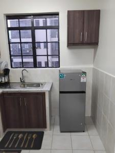 a small kitchen with a sink and a refrigerator at Achievers stays in Kitengela  +2 photos