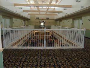 an empty room with a staircase in a building at Days Inn by Wyndham Pentwater in Pentwater