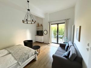 a bedroom with a bed and a living room at Willa 4 Pory Roku & Uznam in Świnoujście