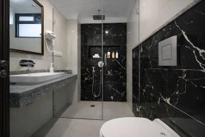 a bathroom with a shower and a toilet and a sink at Hotel Stay Premium- Free Airport Tranffer in New Delhi