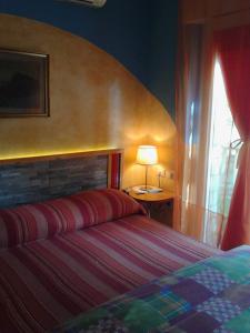 Кровать или кровати в номере La Casa di Ulisse B&B