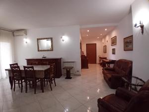 a living room with a table and chairs at Luna Reale Relais e Suite APARTMENTS in San Nicola La Strada