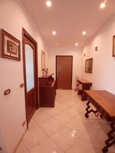 a hallway with a wooden table and a door at Luna Reale Relais e Suite APARTMENTS in San Nicola La Strada +224 photos