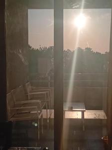 a room with chairs and a table and the sun at Luna Reale Relais e Suite APARTMENTS in San Nicola La Strada