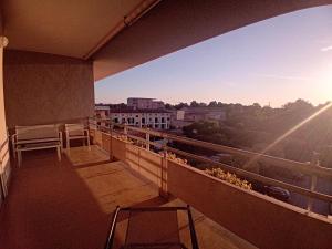 a balcony with chairs and a view of a city at Luna Reale Relais e Suite APARTMENTS in San Nicola La Strada