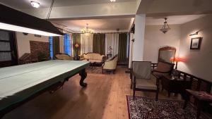a living room with a large bed in the middle of it at Lloyd's Vintage Home in Bhowāli