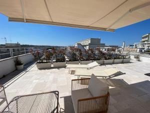a patio with tables and chairs on a roof at Il Pumo in Locorotondo