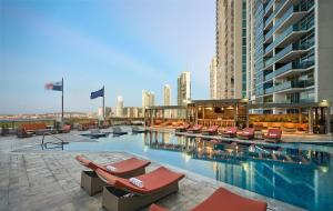 a swimming pool with lounge chairs and a building at Hilton Panama in Panama City