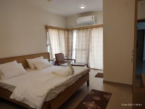 a bedroom with a bed with a cat sitting on it at KAIBALYA Bliss in Jāmb