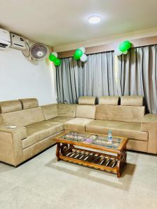 a living room with a couch and a coffee table at KAIBALYA Bliss in Jāmb
