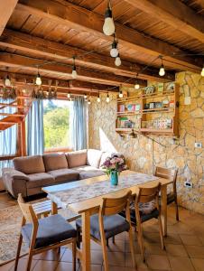 a living room with a table and a couch at Rose Hip Hill Farm in Valea Tîrnei