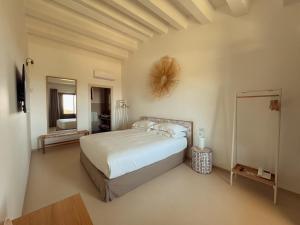 a bedroom with a large bed and a mirror at ORTO NOTO - Agri Resort in Noto +37 photos