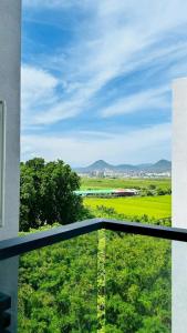 a view of a green field from a balcony at 日沐澄旅 l 家人聚會 l 烤肉 l 戲水池 l 電動麻將 l KTV l 影音TV in Ch'ih-k'an