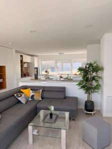 a living room with a couch and a table at Floating-Haus Meerferien in Bitterfeld