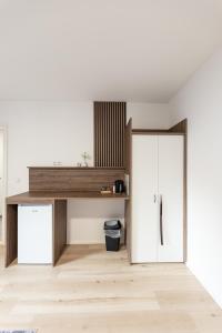 a room with a white door and a wooden floor at ALS Zimmer & Suiten in Lambach +72 photos
