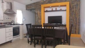 a kitchen with a table with chairs and a dining room at Complejo Jardin Escondido in Villa Icho Cruz