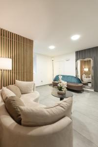 a living room with a couch and a table at ALS Zimmer & Suiten in Lambach