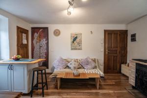 a living room with a bed and a table at Andrea's Nido in Castel del Piano
