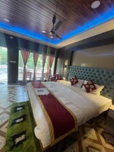 a large bedroom with a large bed with blue lights at Jungle Beach Resort in Neil Island