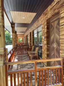 a large wooden deck with chairs on it at Jungle Beach Resort in Neil Island +16 photos