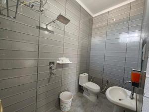 a bathroom with a toilet and a sink at Samlaun in Pauri +70 photos