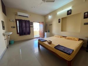 a bedroom with a bed with two towels on it at Geetham Homestay in Tiruchirappalli +33 photos