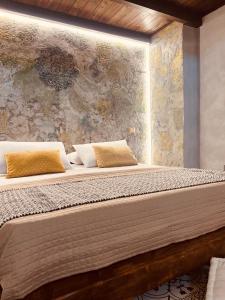 a bedroom with a large bed with a wall at Antica e luminosa masseria in Lequile