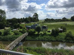 a bridge over a river with a boat in a field at Mein Horumersiel in Horumersiel