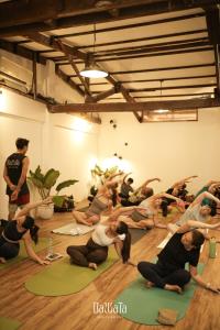 a group of people doing yoga in a room at Eia by Dawata Boutique Stay, Yoga & Cafe in Cebu City