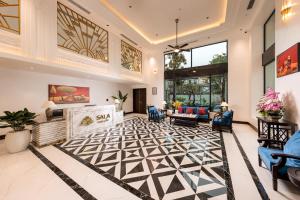 a living room with a black and white patterned floor at SaLa Tam Coc Hotel & Spa in Ninh Binh +46 photos