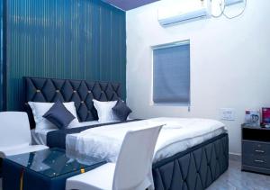 a bedroom with a large bed and a chair at Hotel skyline in Visakhapatnam