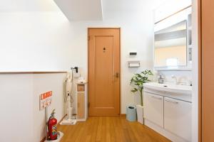 a small kitchen with a sink and a door at The triangle hub Miyazaki in Miyazaki +68 photos