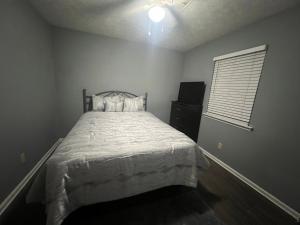 a bedroom with a large bed and a window at Sweet Spot Stone Mountain in Stone Mountain