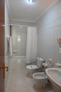 a white bathroom with a toilet and a sink at Hotel Venta El Puerto in Murcia +80 photos