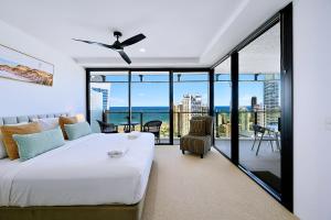 a bedroom with a large white bed and a balcony at Circle On Cavill Surfers Paradise Apartments-Holiday Paradise in Gold Coast +44 photos