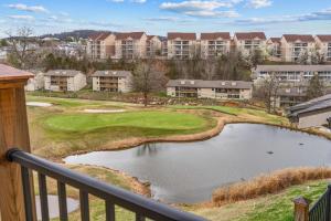 a view of a golf course with a pond at Hole-in-One Hideaway For 4 in Branson