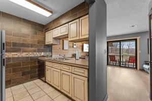 a large kitchen with a sink and a counter at Hole-in-One Hideaway For 4 in Branson +27 photos