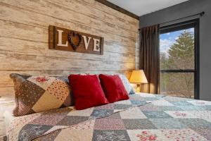 a bedroom with a bed with a quilt and pillows at Hole-in-One Hideaway For 4 in Branson