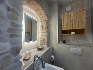 a bathroom with a sink and a window at Boutique Rooms Malo More - Old Town and Parking in Trogir +39 photos